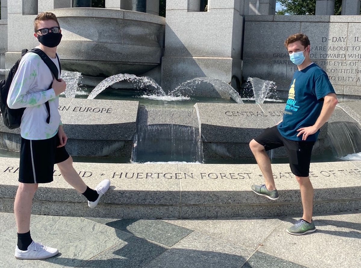 Interns posing by a fountain