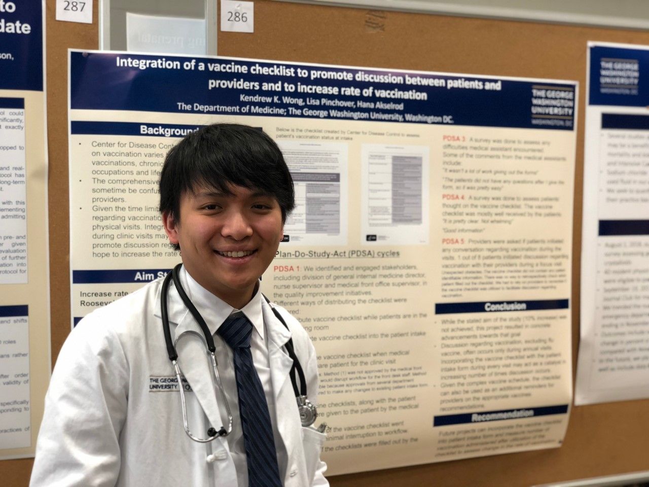 GW Resident posing with his research presentation